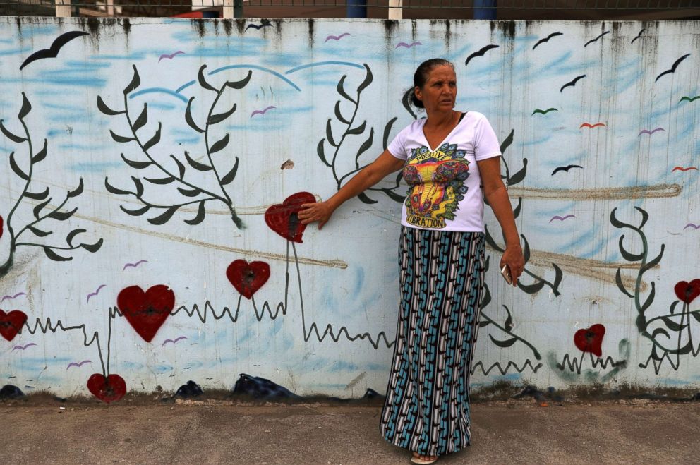 PHOTO: Rosilene Alves touches bullet holes in a wall outside her daughter's school in Pedreira in Rio de Janeiro, April 22, 2018. Alves's daughter, Maria Eduarda Alves, was shot dead at school in 2017 when she was 13-years-old.