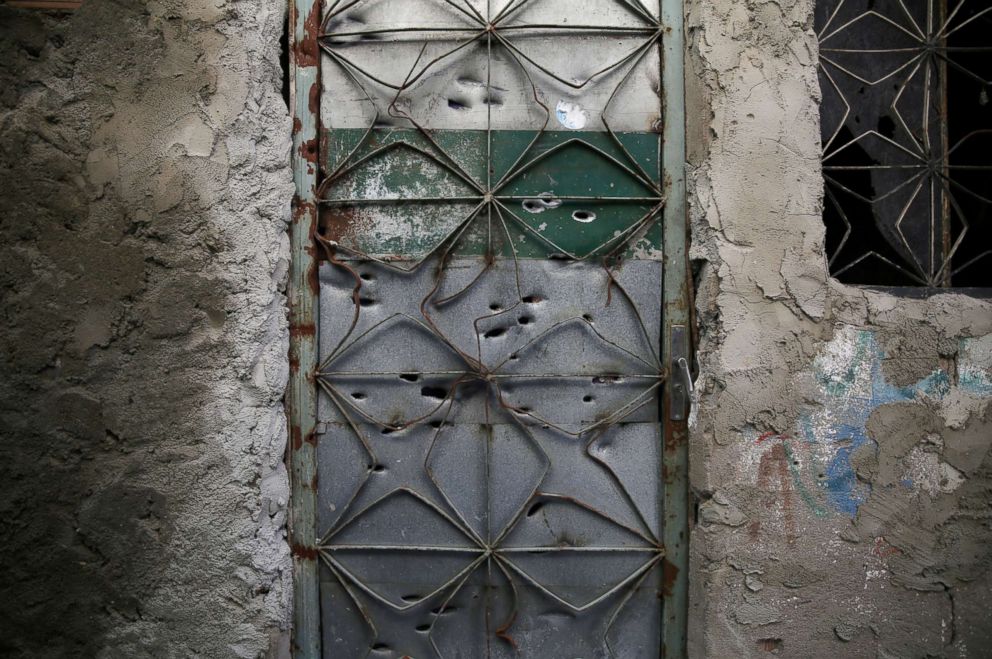 PHOTO: The front door of an abandoned house which is damaged by bullet holes, is seen in a passage known as "beco da Siria" in Jacarezinho in Rio de Janeiro, Jan. 10, 2018.