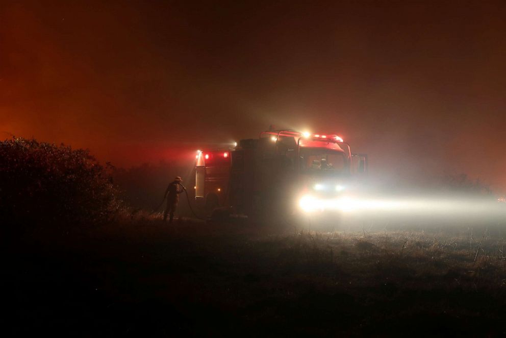 PHOTO: A firefighter holds a hose as he attempts to extinguish a fire on a ranch in the Pantanal, the world's largest wetland, in Pocone, Mato Grosso state, Brazil, Aug. 26, 2020.