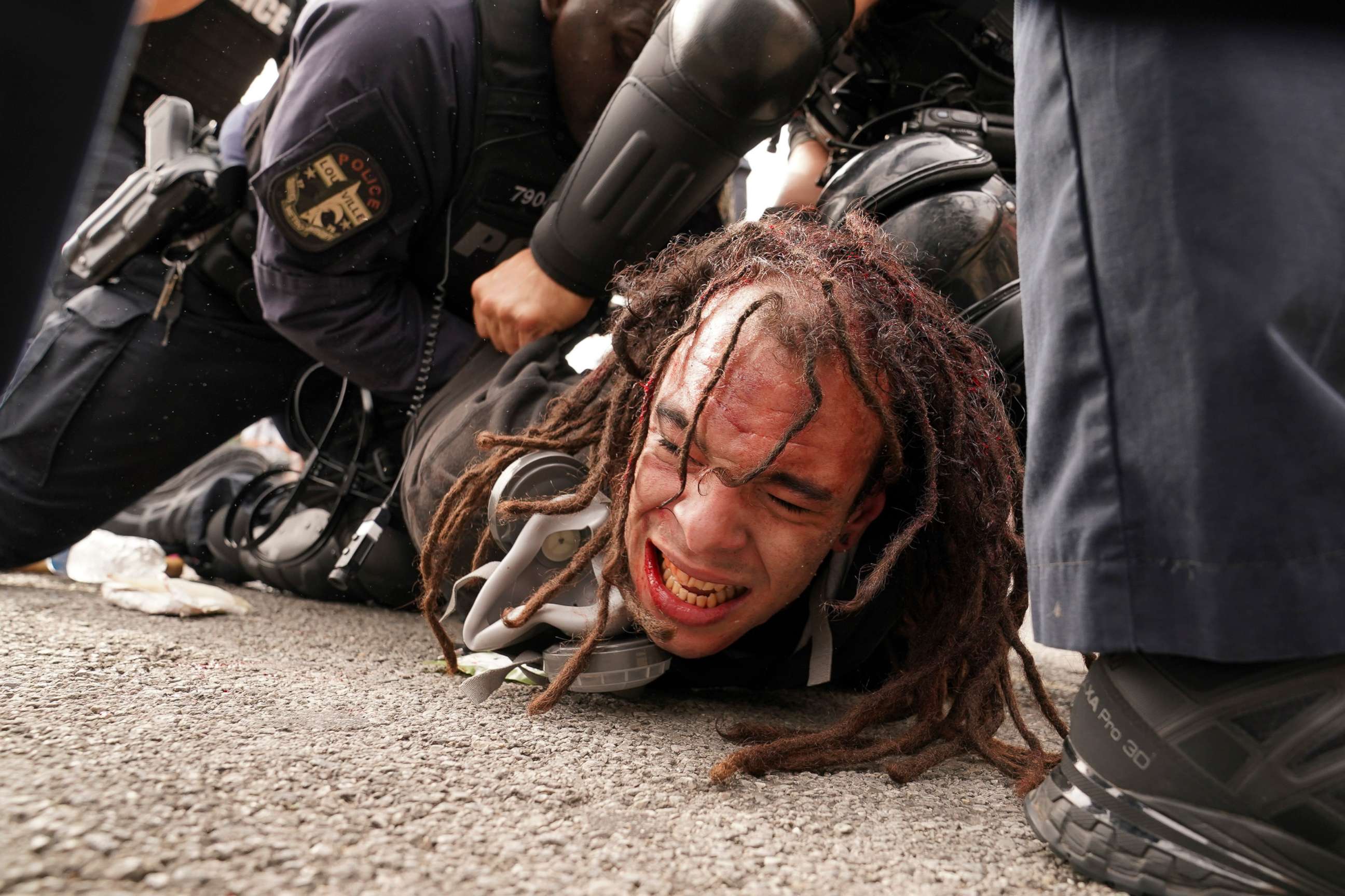 PHOTO: Louisville police detain a man after a group marched, Sept. 23, 2020, in Louisville, Ky. A grand jury indicted one officer on criminal charges six months after Breonna Taylor was fatally shot by police in Kentucky.