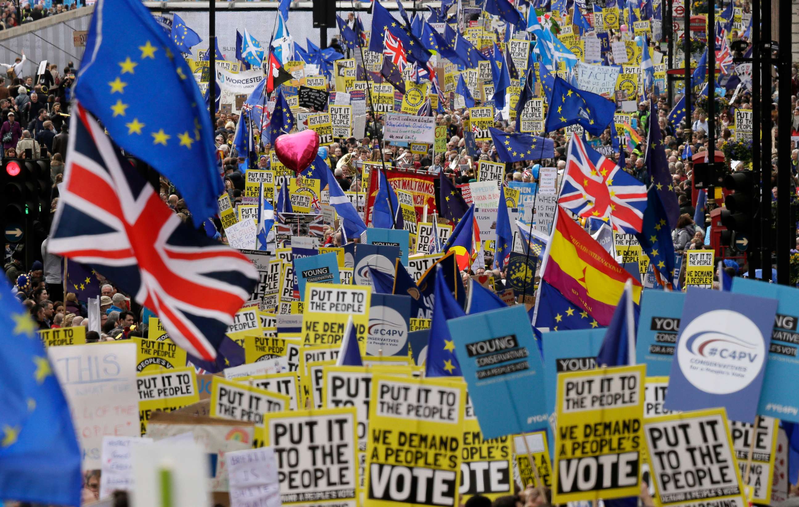 PHOTO: Demonstrators carry posters and flags during a Peoples Vote anti-Brexit march in London, March 23, 2019. 