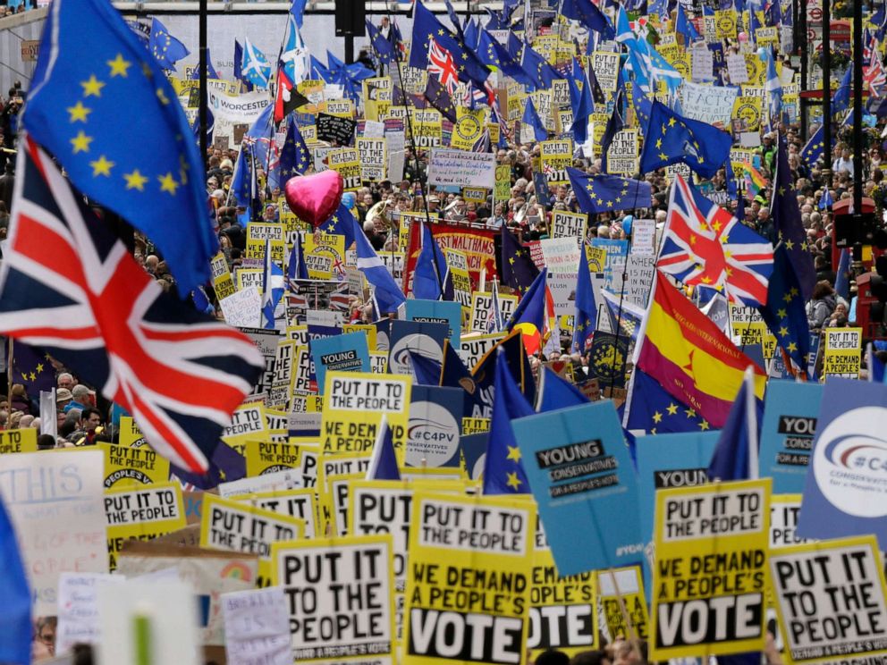 PHOTO: Demonstrators carry posters and flags during a Peoples Vote anti-Brexit march in London, March 23, 2019.