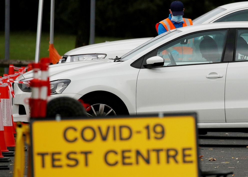 PHOTO: A person speaks to someone in their car at a drive-through testing center in Bolton, Britain, Sept. 22, 2020.