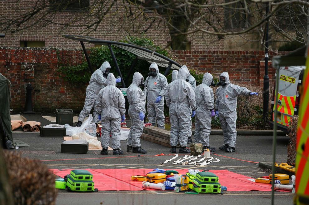 PHOTO: Military personnel wearing protective coveralls set up for an operation in a cordoned off area behind a police station in Salisbury, England, March 11, 2018.