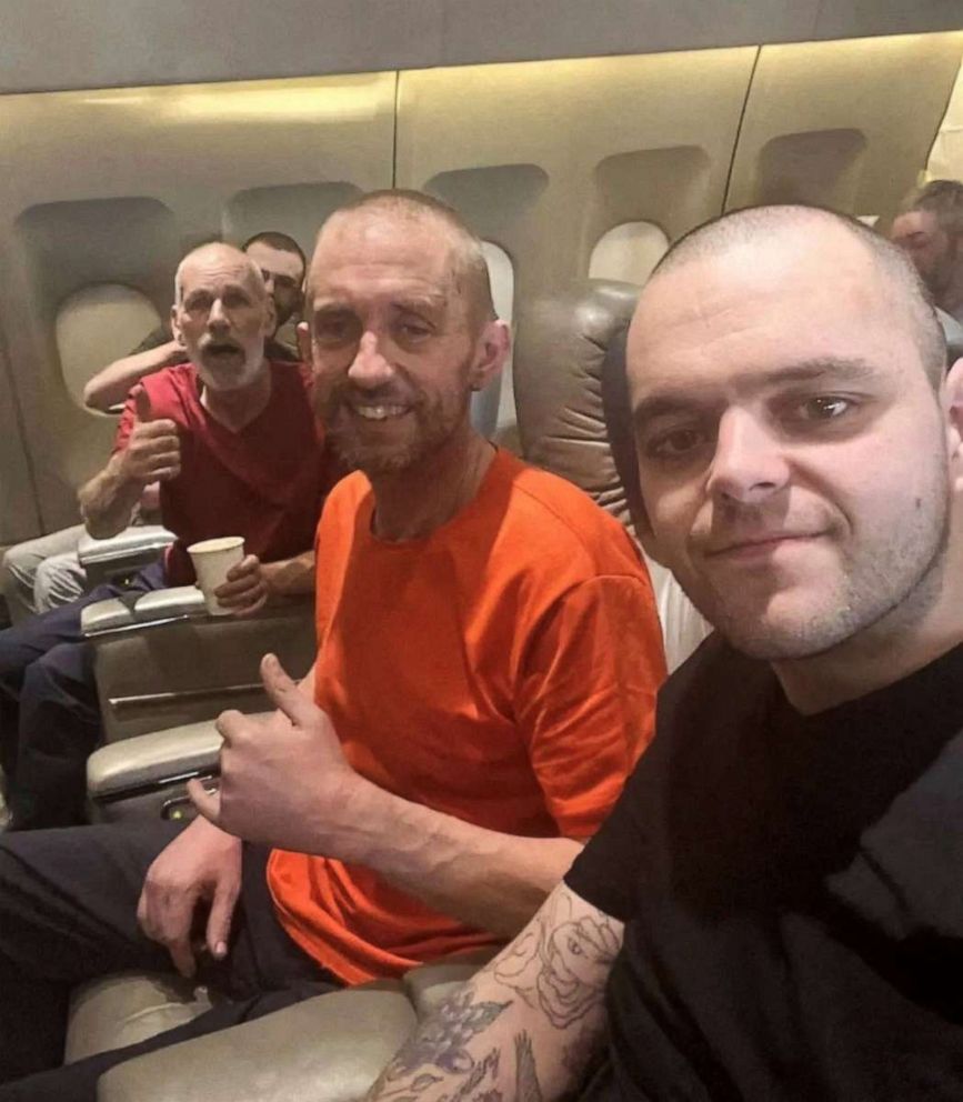 PHOTO: British prisoners of war pose for a photo on a plane following their release from Russian captivity after fighting for Ukraine, in this screen grab of a video obtained from social media.
