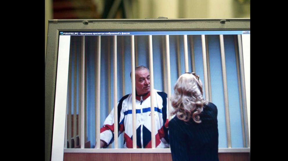 Sergei Skripal speaks to his lawyer from behind bars seen on a screen of a monitor outside a courtroom in Moscow in this Aug. 9, 2006 file photo.