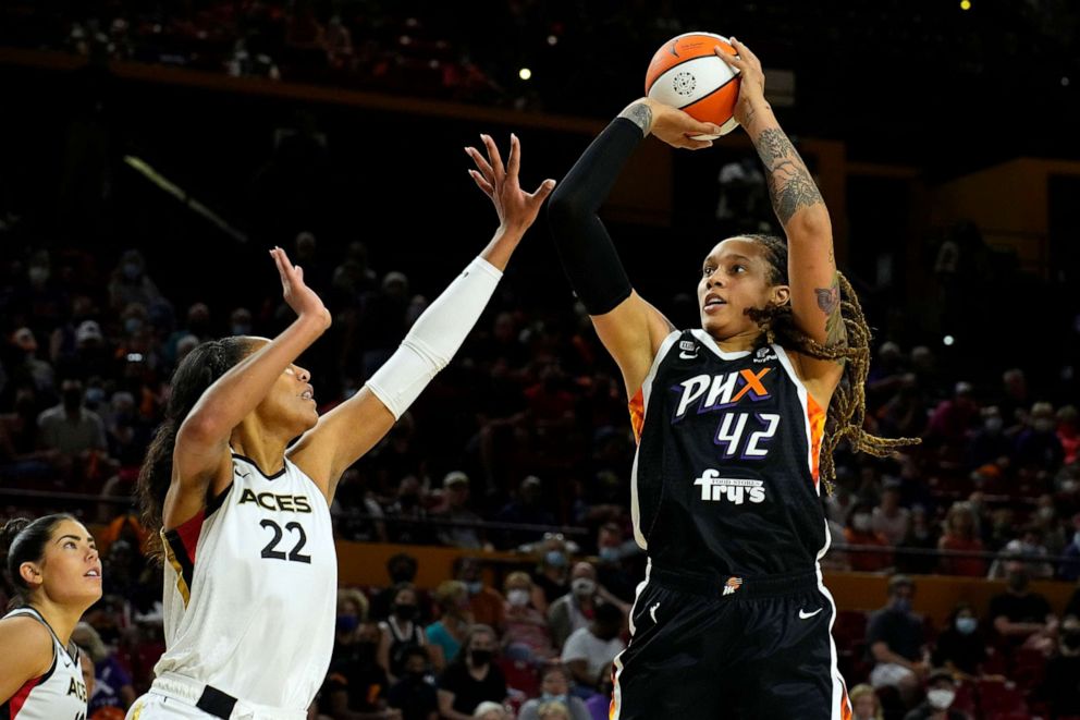 PHOTO: In this Oct. 3, 2021, file photo, Phoenix Mercury center Brittney Griner shoots over Las Vegas Aces forward A'ja Wilson during the first half of a WNBA basketball game in Phoenix.