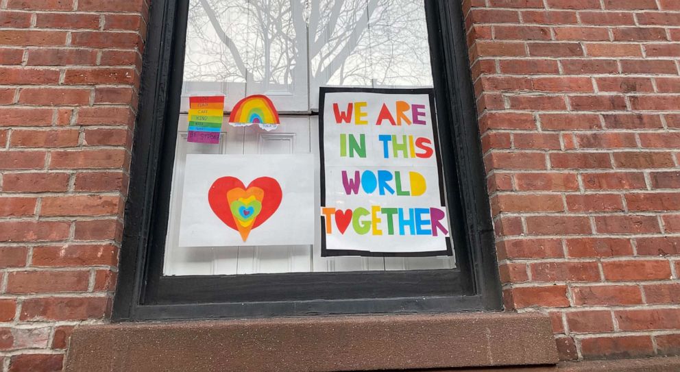 PHOTO: Pictures drawn by children hang from a window as part of the Quarantine Rainbow Project in Brooklyn, New York, March 18, 2020.