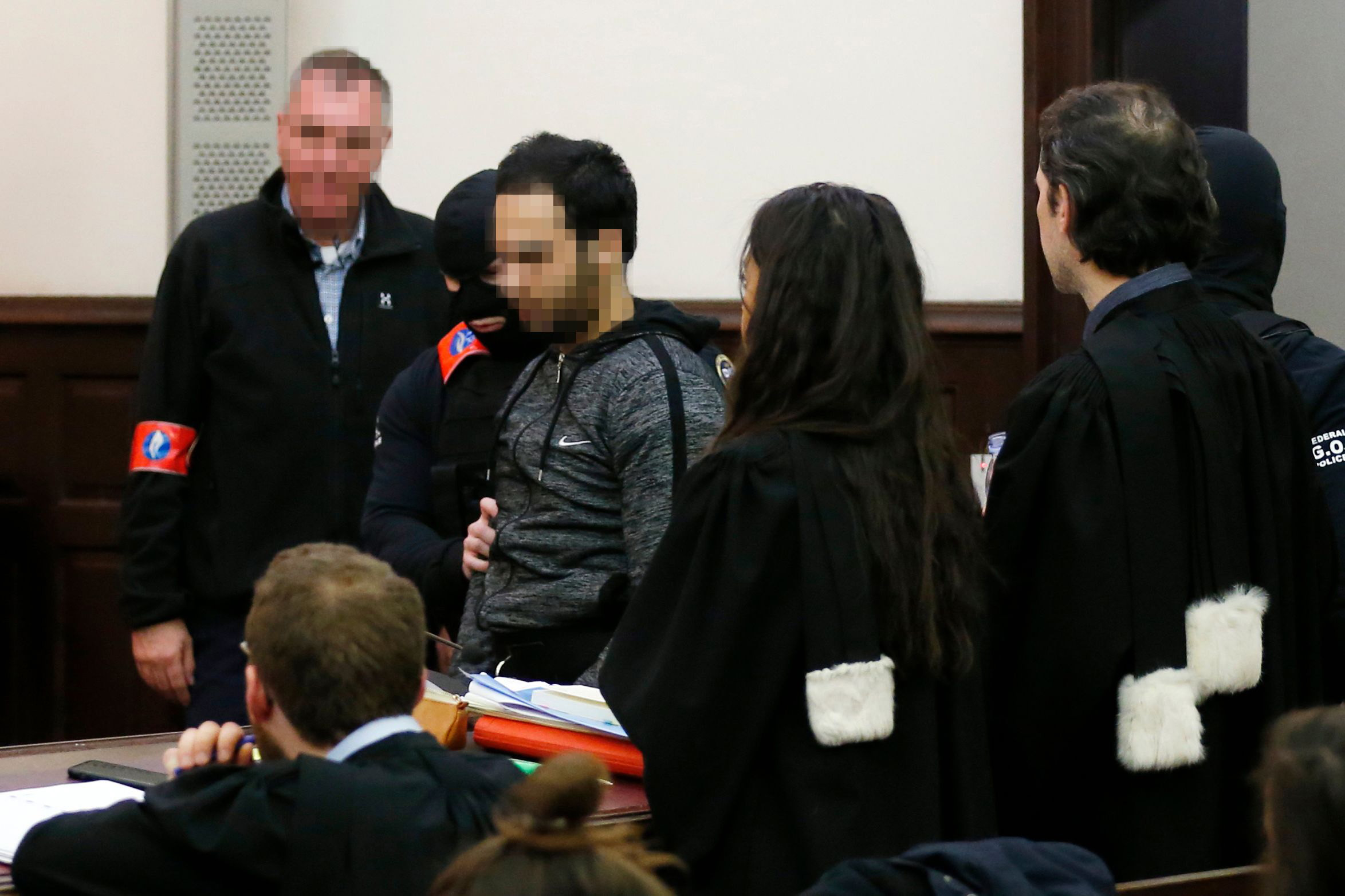 PHOTO: The alleged accomplice of the November 2015 Paris attacks suspect Salah Abdeslam, Sofiane Ayari, center, is escorted by Belgian police officers as he arrives in a courtroom in Brussels on Feb. 8, 2018.