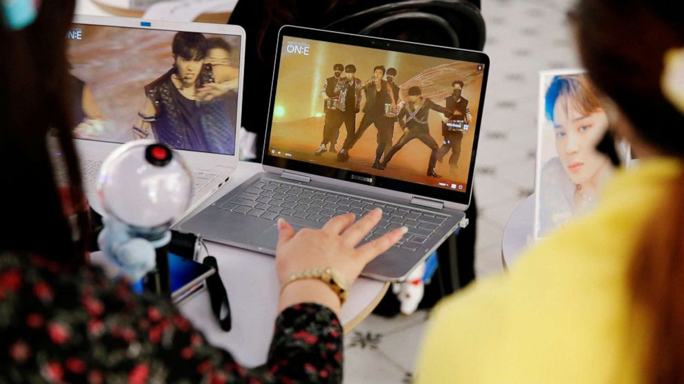 FILE PHOTO: Fans of K-pop idol boy band BTS watch a live streaming online concert at a cafe in Seoul, South Korea, on Oct. 10, 2020. 