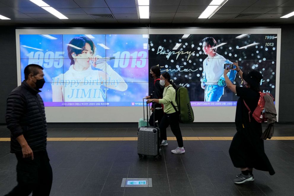 PHOTO: People pass by a screen installed to celebrate the birthday of Jimin, a member of South Korean K-pop band BTS, at a subway station in Seoul, South Korea, on Oct. 13, 2022.