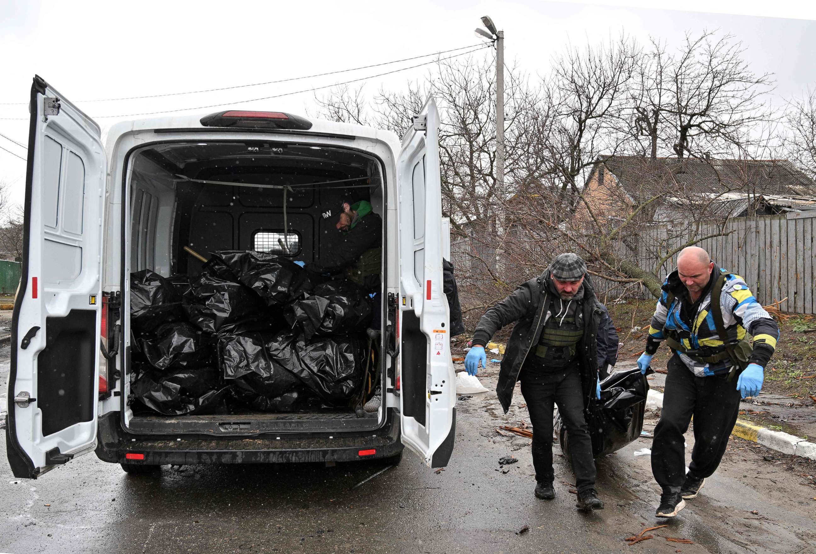 PHOTO: Communal workers carry a body of a civilian man killed in the town of Bucha, not far from the Ukrainian capital of Kyiv on April 3, 2022.