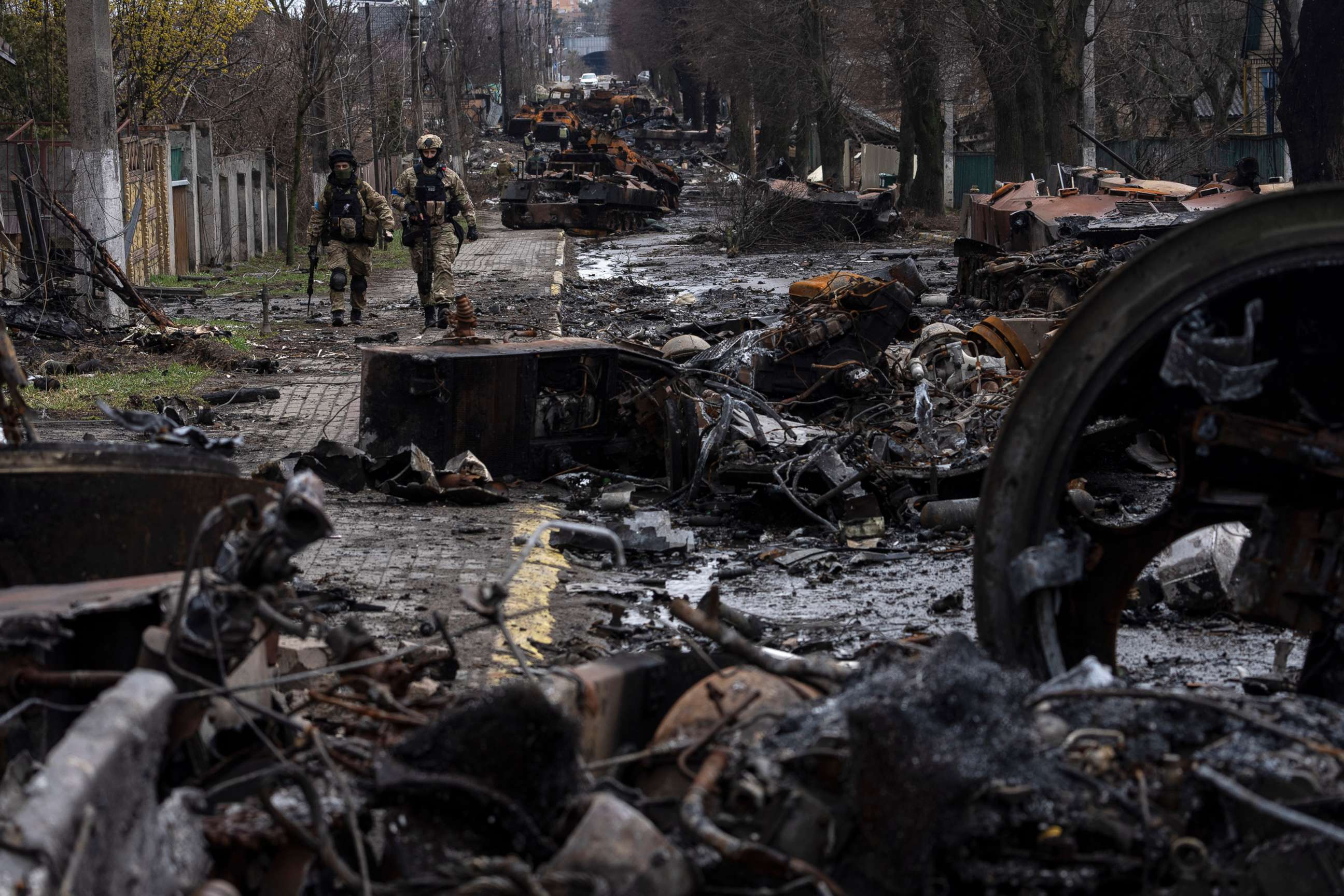 PHOTO: Soldiers walk amid destroyed Russian tanks in Bucha, in the outskirts of Kyiv, Ukraine, April 3, 2022.