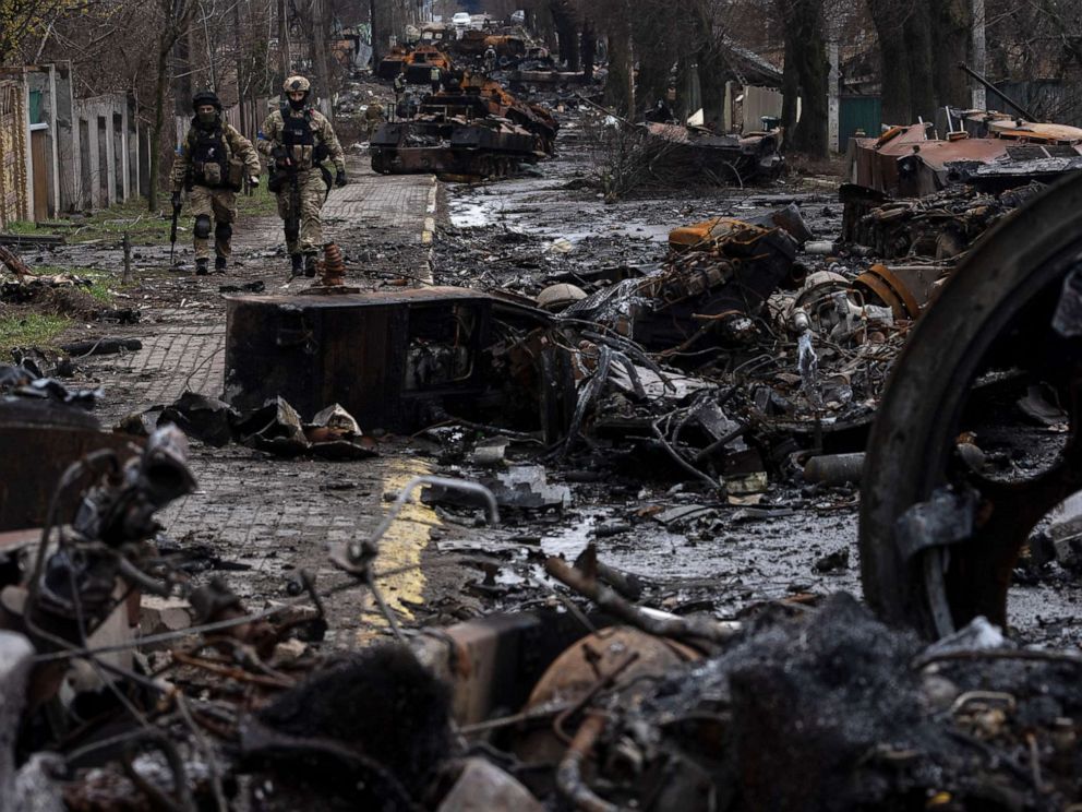 PHOTO: Soldiers walk amid destroyed Russian tanks in Bucha, in the outskirts of Kyiv, Ukraine, April 3, 2022.