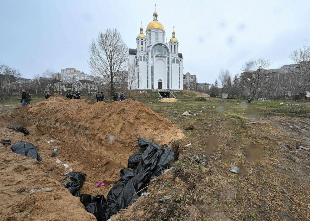 PHOTO: A mass grave is seen behind the Church of St. Andrew and Pyervozvannoho All Saints in the town of Bucha, northwest of Kyiv, Ukraine, on April 3, 2022.