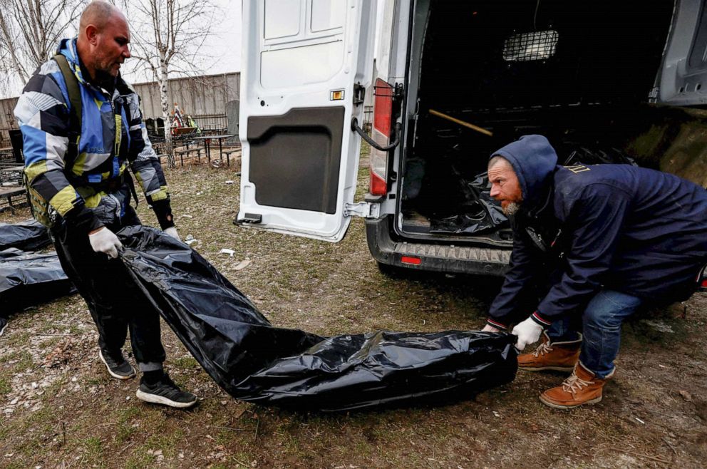 PHOTO: Volunteers unload bags containing bodies of civilians, who according to residents were killed by Russian army soldiers, after they collected them from the streets in Bucha, Ukraine April 4, 2022.