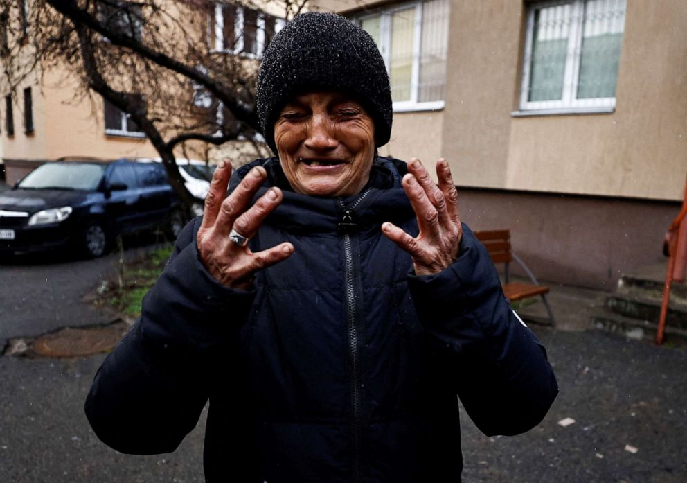 PHOTO: Tanya Nedashkivska reacts as she recounts how her husband Vasyl Ivanovych, who served in the navy, was killed by Russian soldiers, as she stands near their residential building in Bucha, Ukraine, April 3, 2022.