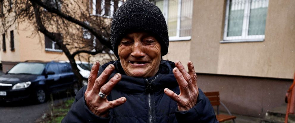 PHOTO: Tanya Nedashkivska reacts as she recounts how her husband Vasyl Ivanovych, who served in the navy, was killed by Russian soldiers, as she stands near their residential building in Bucha, Ukraine, April 3, 2022.