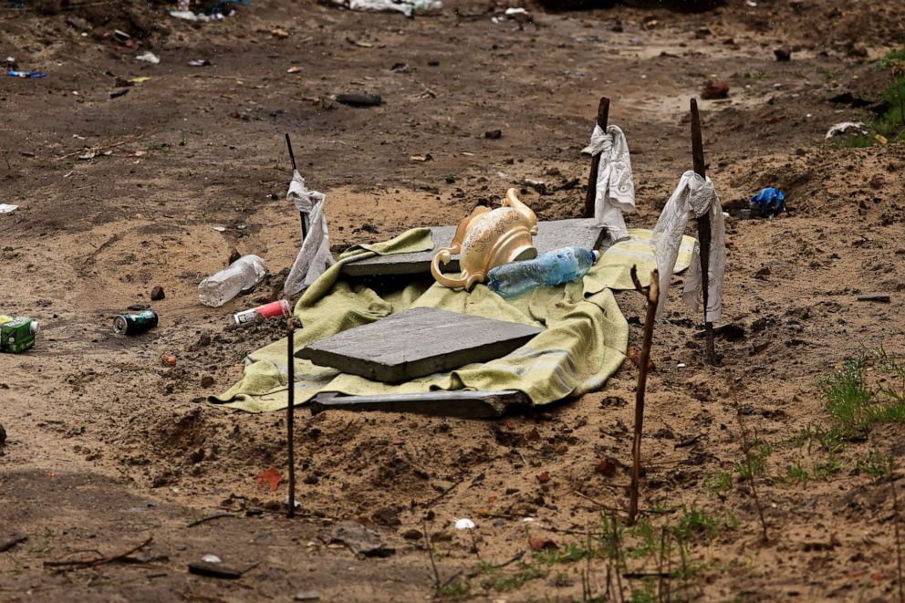 PHOTO: A grave where two men have been buried is seen at the garden of a building in Bucha, Ukraine, April 3, 2022.