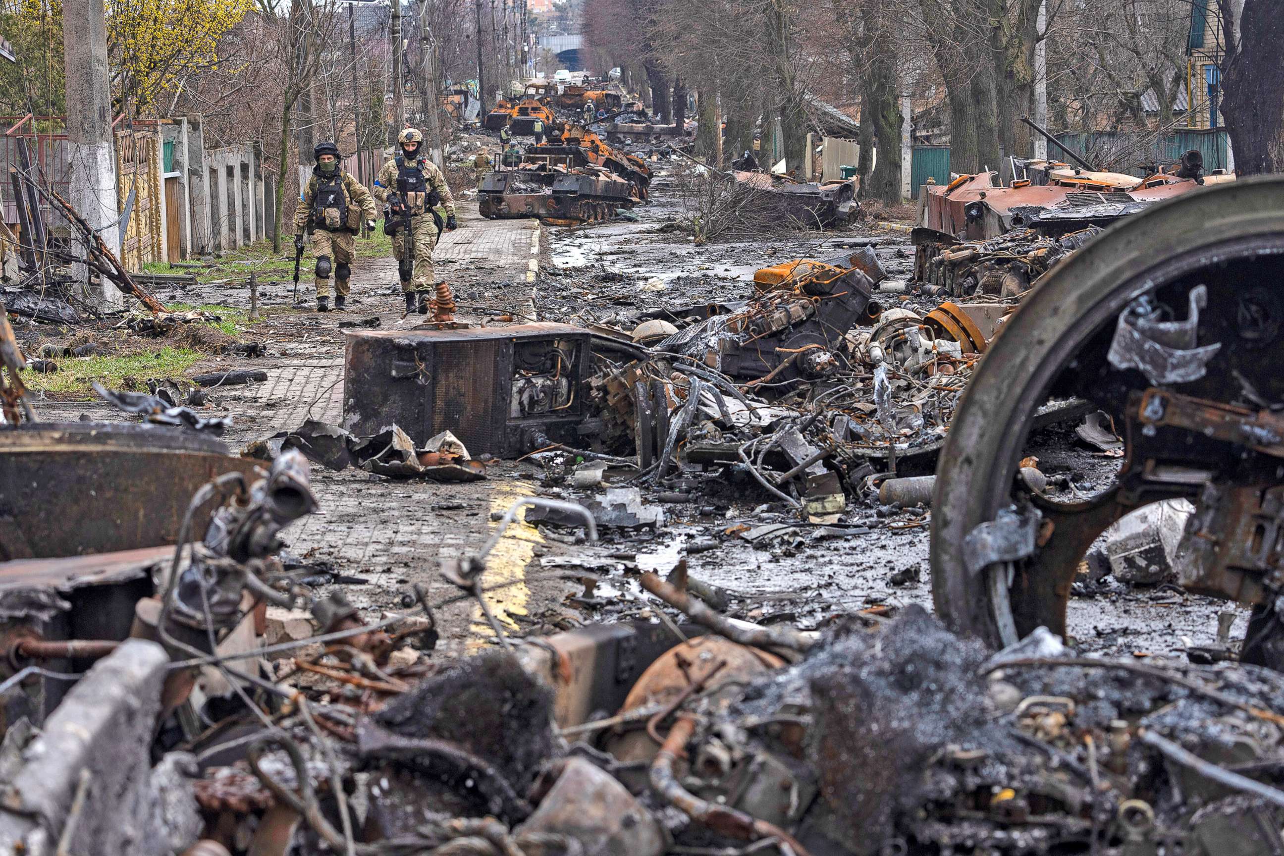 PHOTO: Soldiers walk amid destroyed Russian tanks in Bucha, on the outskirts of Kyiv, Ukraine, April 3, 2022.  