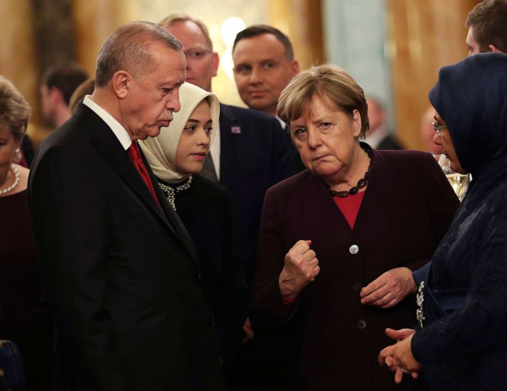 PHOTO: Turkish President Recep Tayyip Erdogan, left, speaking with Chancellor of Germany, Angela Merkel, during a formal reception for the heads of the NATO countries, at Buckingham palace in London, Dec. 3, 2019. 