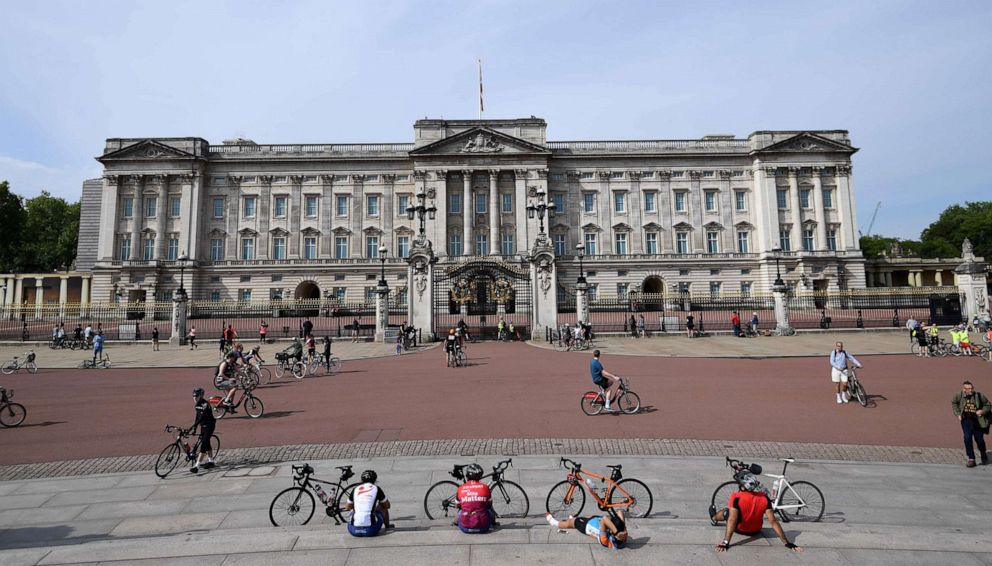 PHOTO: Cyclists rest in front of Buckingham palace, May 8, 2020, in London.