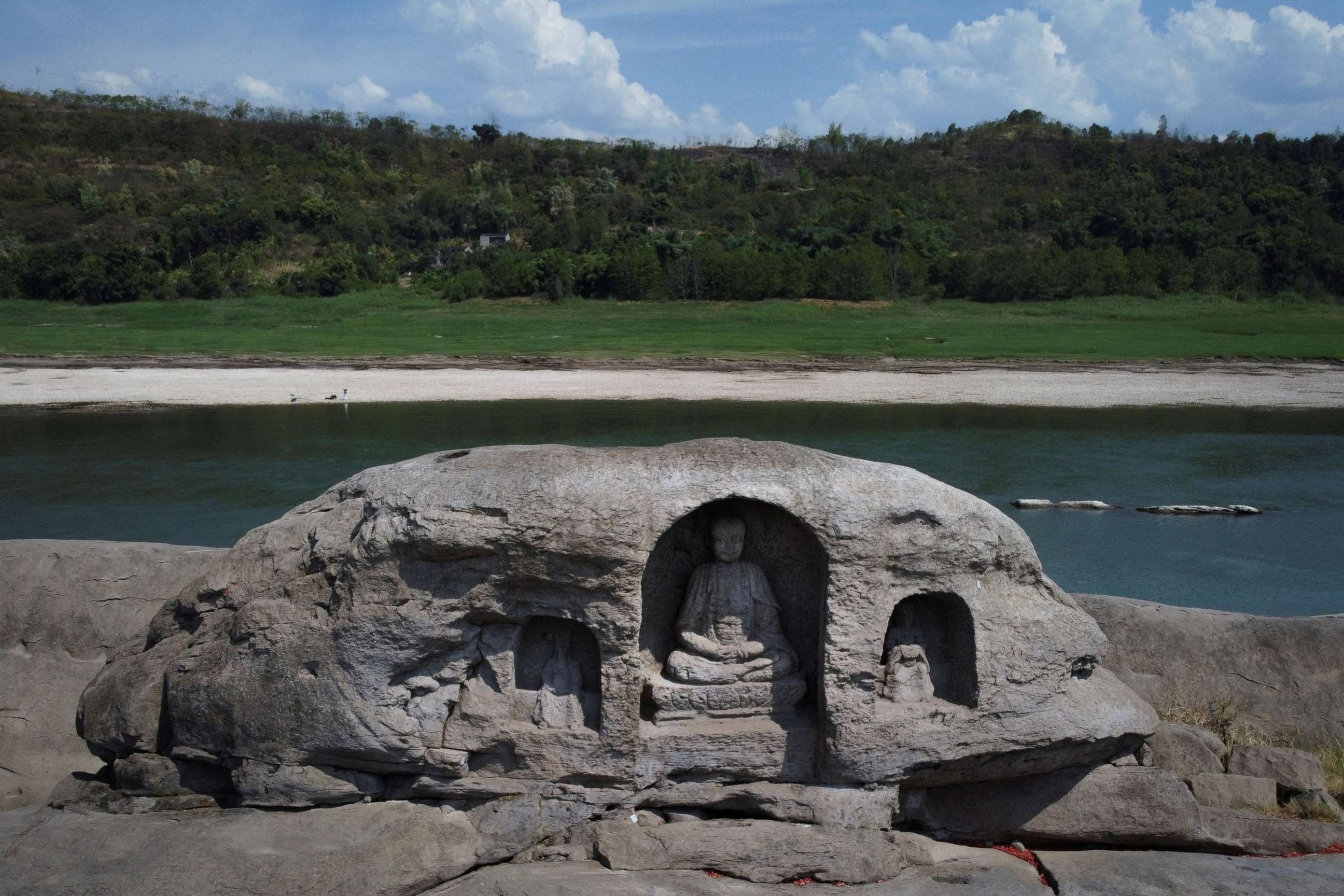 PHOTO: A once submerged Buddhist statue sits on top of Foyeliang island reef in the Yangtze river, which appeared after water levels fell due to a regional drought in Chongqing, China, August 20, 2022.