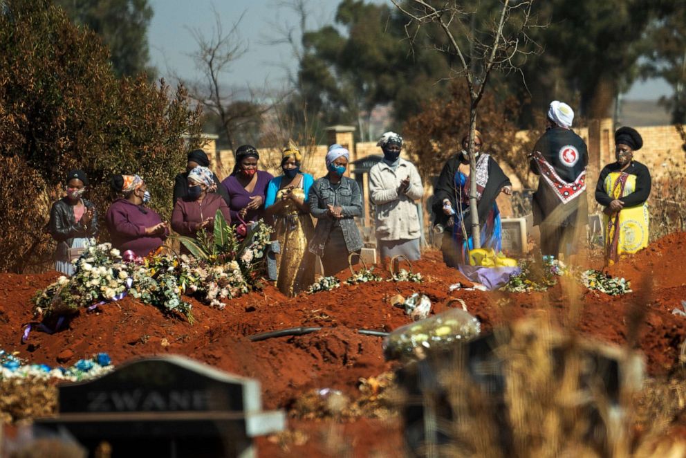 PHOTO: Mourners pray during a burial ceremony at the Olifantsveil Cemetery outside Johannesburg, South Africa, on Aug. 6, 2020.