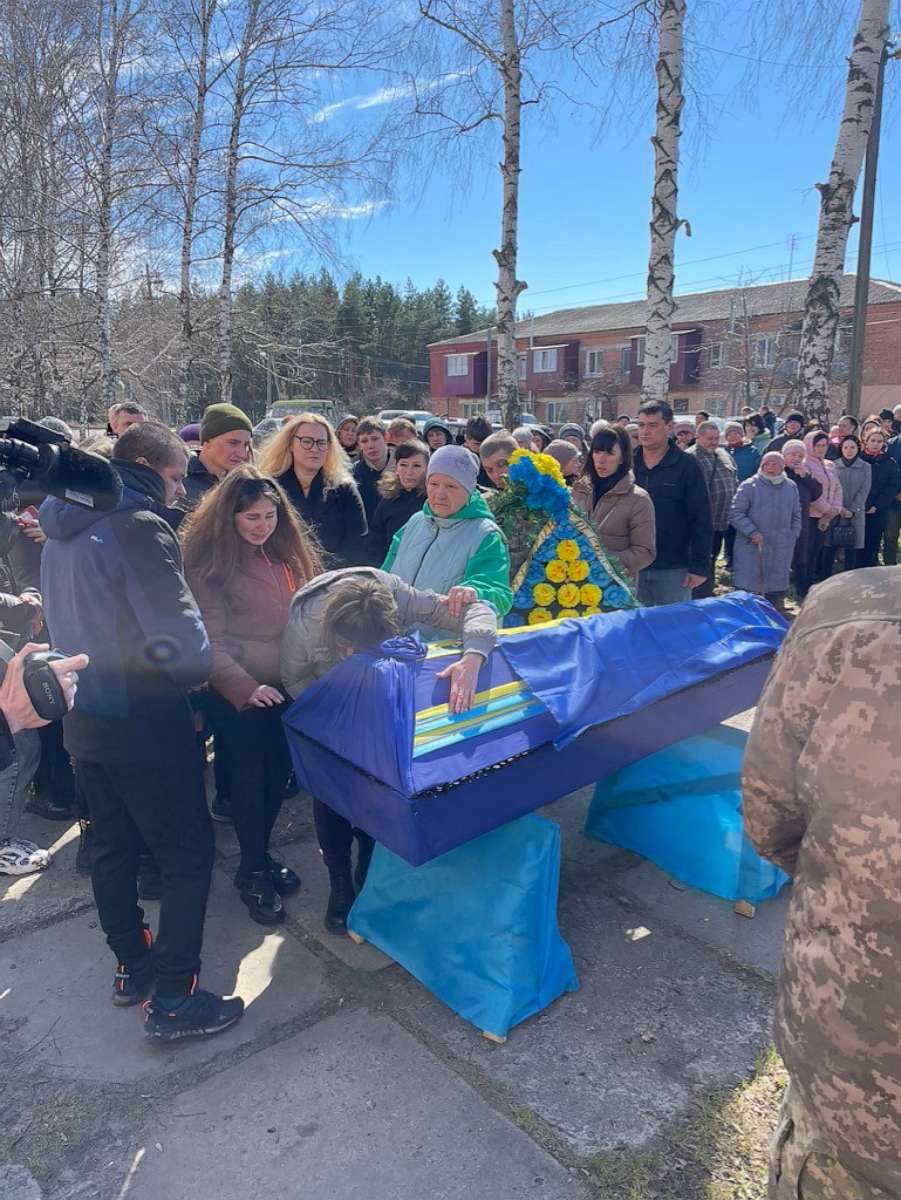 PHOTO: Tetyana Taranukha hugging the coffin of her son, Yuriy Taranukha, at his funeral in their home town of Zmiiv in the Kharkiv region.