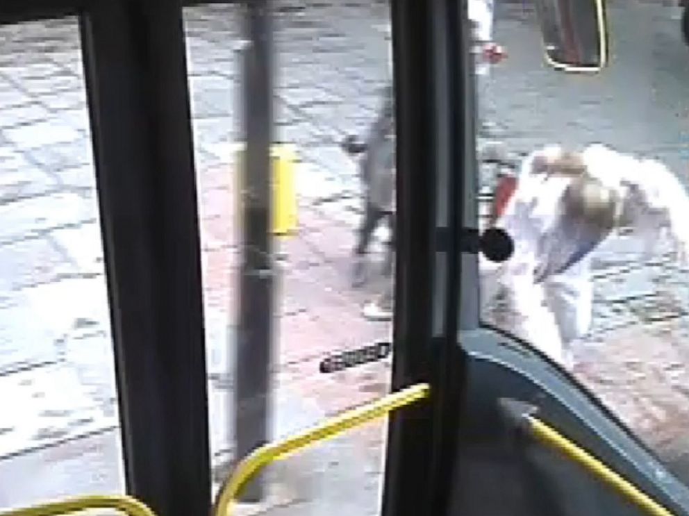 PHOTO:  A woman is seen in CCTV footage shoving another woman off a sidewalk and into the path of an oncoming bus, London, May 29, 2018.
