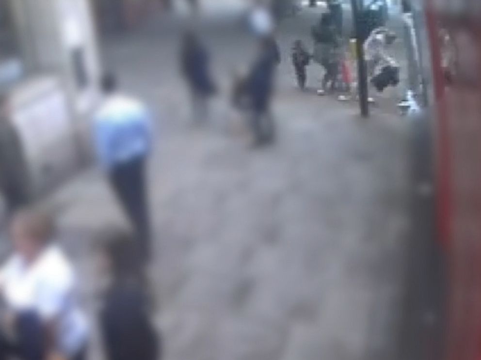 PHOTO:  A woman is seen in CCTV footage shoving another woman off a sidewalk and into the path of an oncoming bus, London, May 29, 2018.
