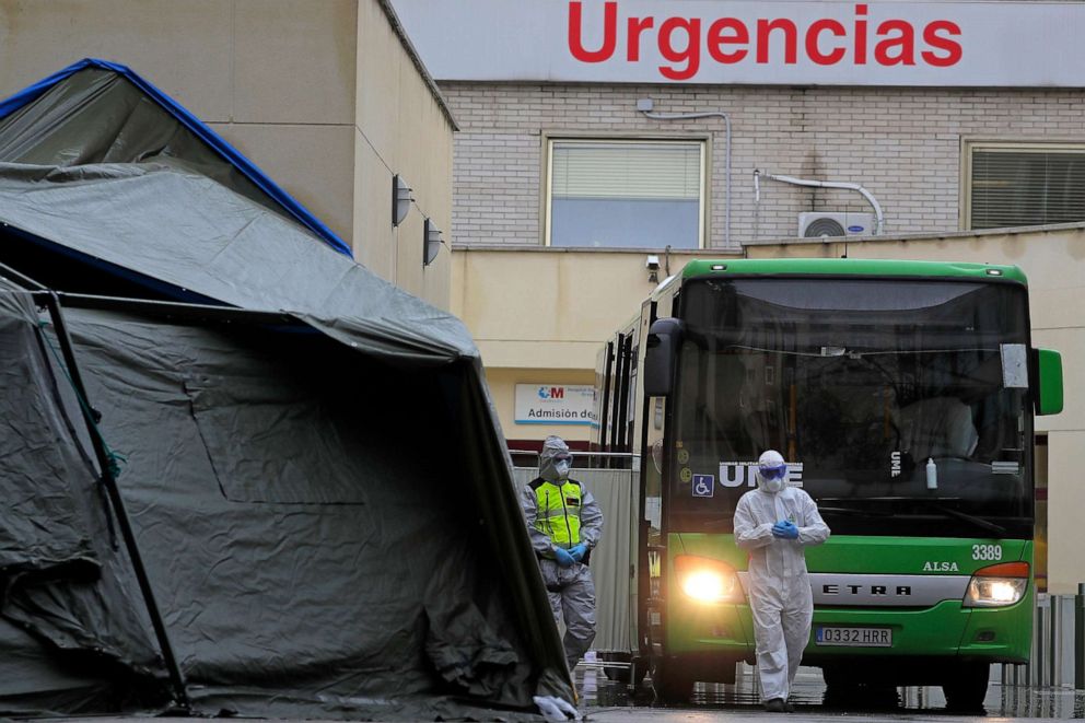 PHOTO: A member of Spain's Emergency Army Unit stands next to a bus carrying COVID-19 patients who are waiting to be transported from Gregorio Maranon hospital to a temporary hospital in Madrid, Spain, on April 1, 2020.