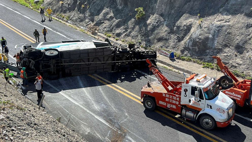PHOTO: Tow trucks and authorities work at the area of a road accident, which left over a dozen passengers dead, in Tepelmeme Villa de Morelos, Oaxaca state, Mexico, on Aug. 22, 2023.