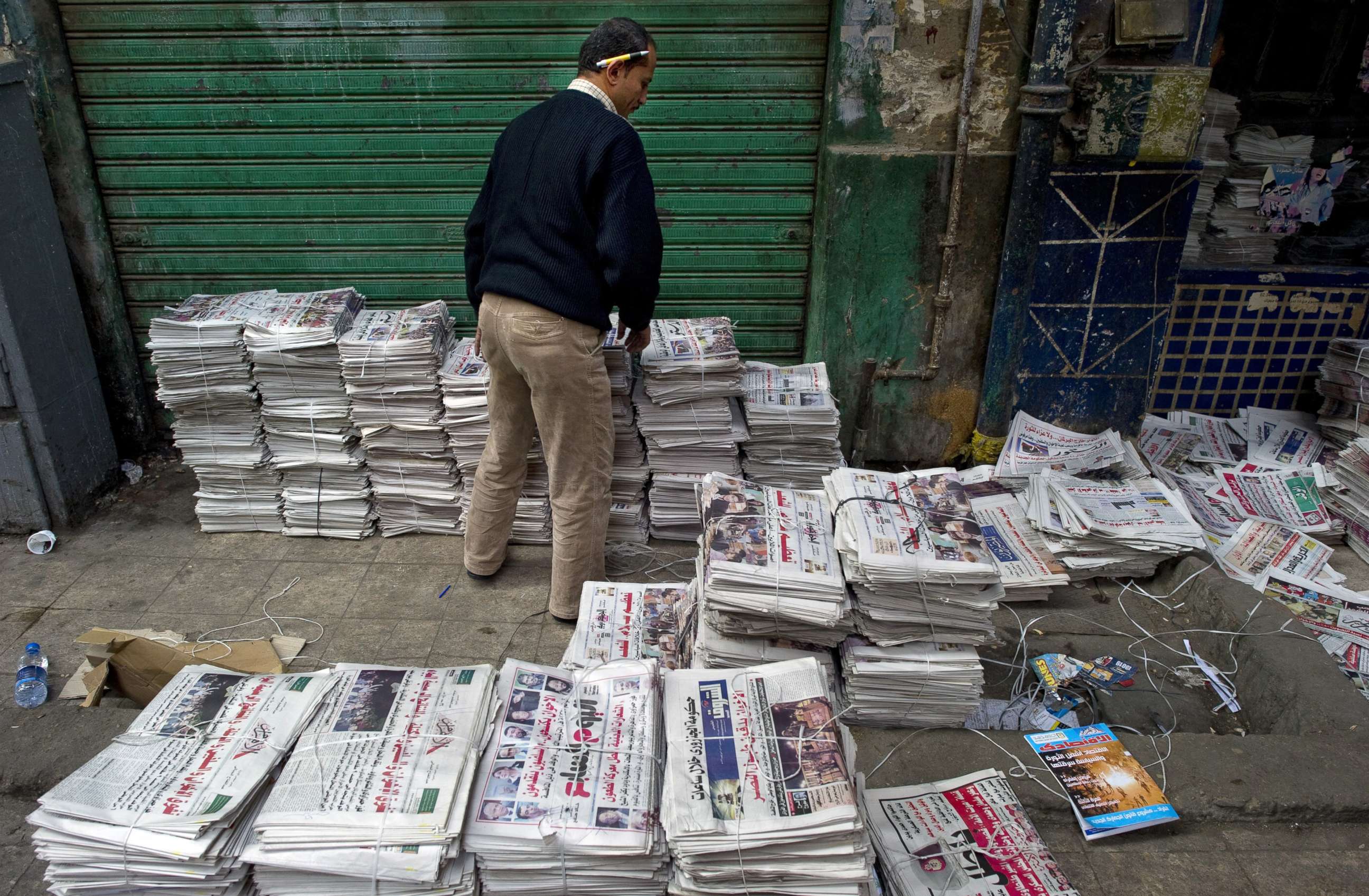 PHOTO: An Egyptian man sorts newspapers at a distribution center just off Tahrir Square in Cairo, Egypt, Dec. 2, 2011.