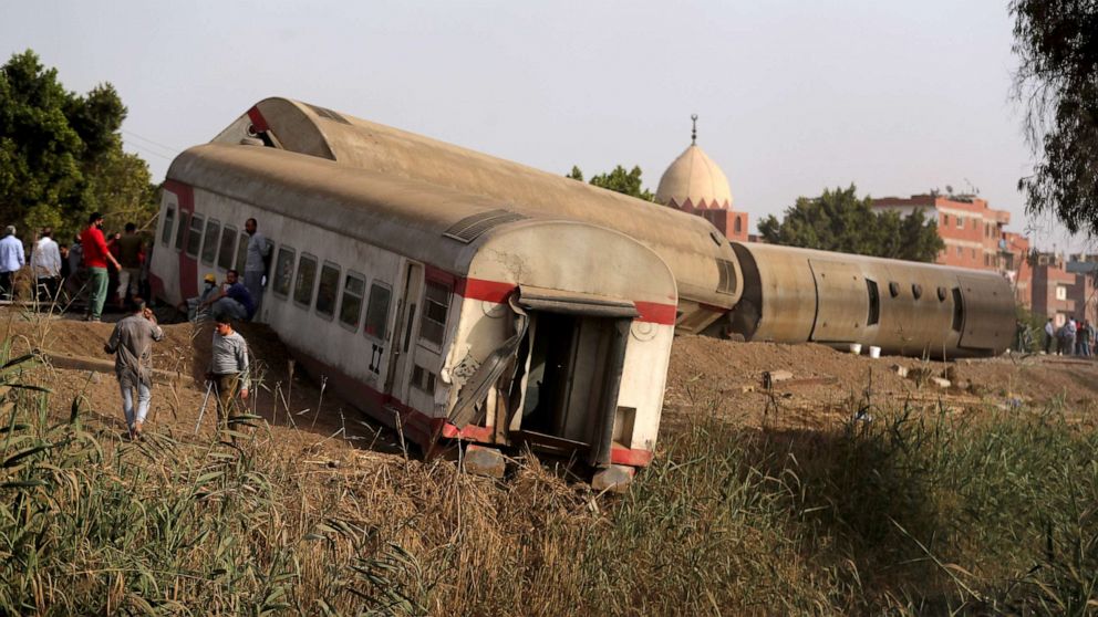 PHOTO: People gather at the site where train carriages derailed in Qalioubia north of Cairo, Egypt, April 18, 2021.