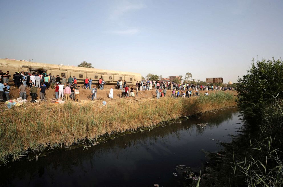 PHOTO: People gather at the site where train carriages derailed in Qalioubia north of Cairo, Egypt, April 18, 2021.