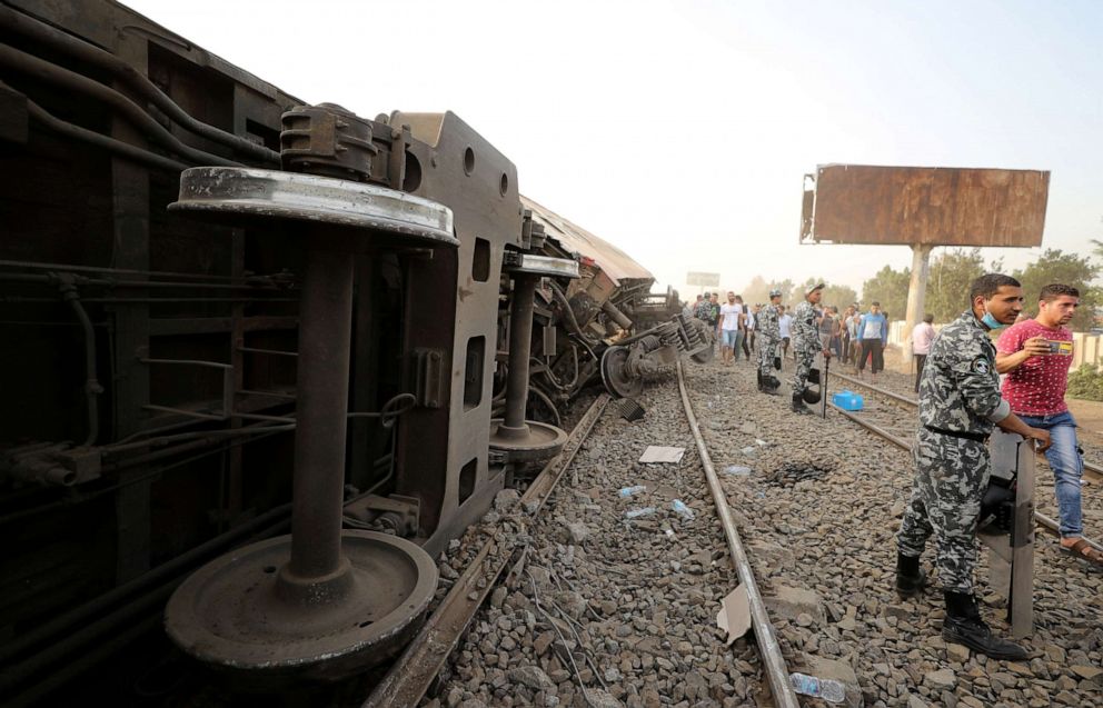 PHOTO: Egyptian police officers stand guard at the site where train carriages derailed in Qalioubia north of Cairo, Egypt, April 18, 2021.