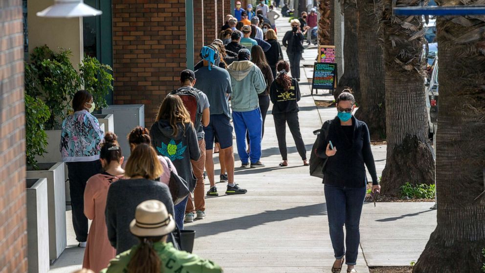 PHOTO: People line up outside a grocery store using social distancing guidelines in Santa Monica, Calif., April 13, 2020. 