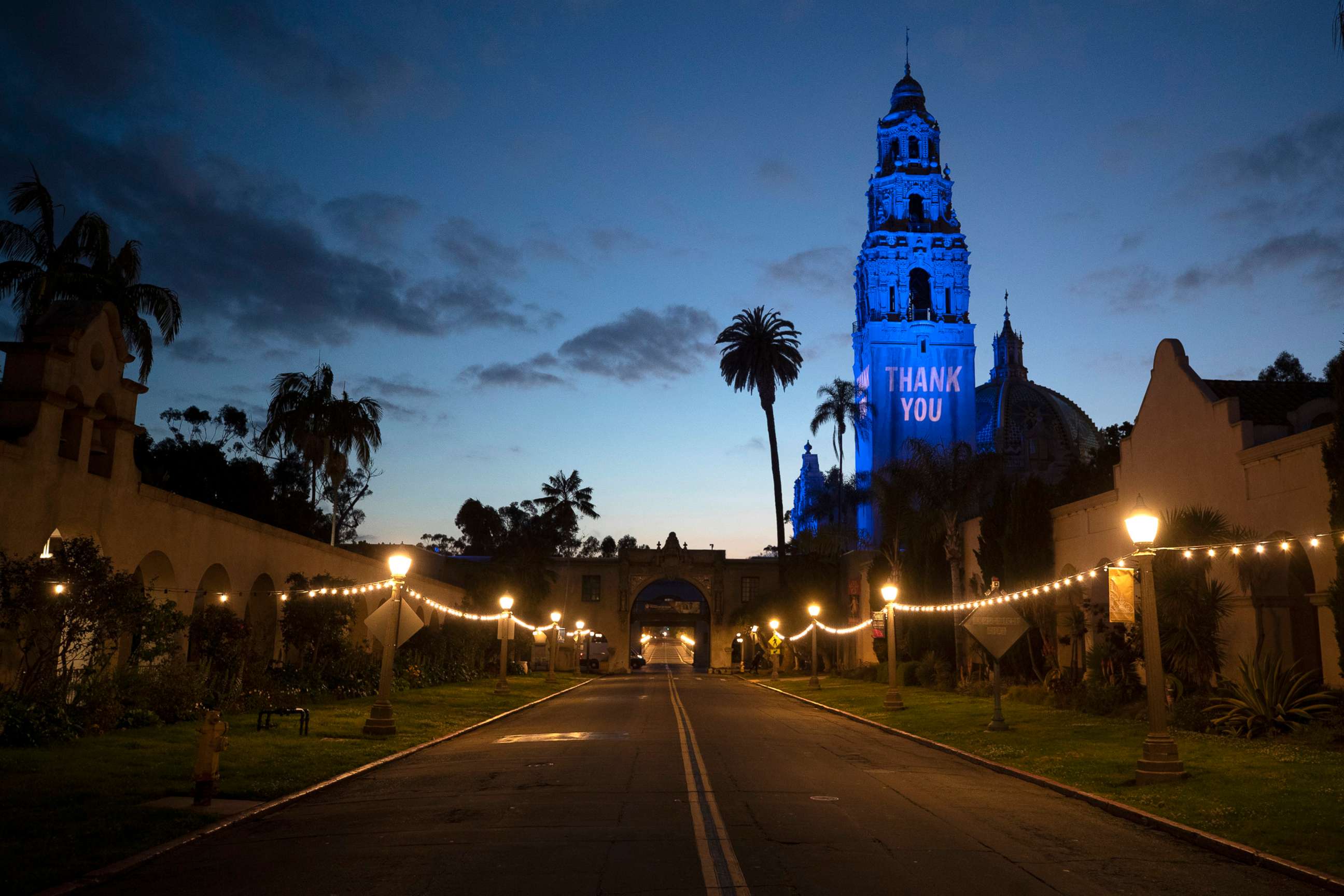 PHOTO: A "Thank You" message and blue floodlights in honor of health care workers and first responders battling the new coronavirus are visible on the California Tower and Museum of Man in an empty Balboa Park, April 13, 2020, in San Diego.