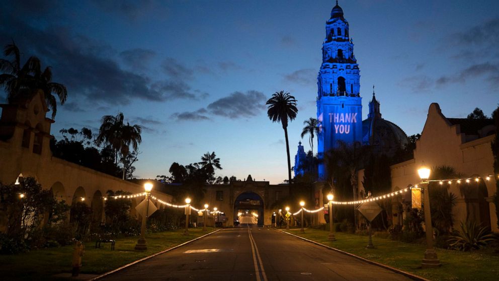 PHOTO: A "Thank You" message and blue floodlights in honor of health care workers and first responders battling the new coronavirus are visible on the California Tower and Museum of Man in an empty Balboa Park, April 13, 2020, in San Diego.