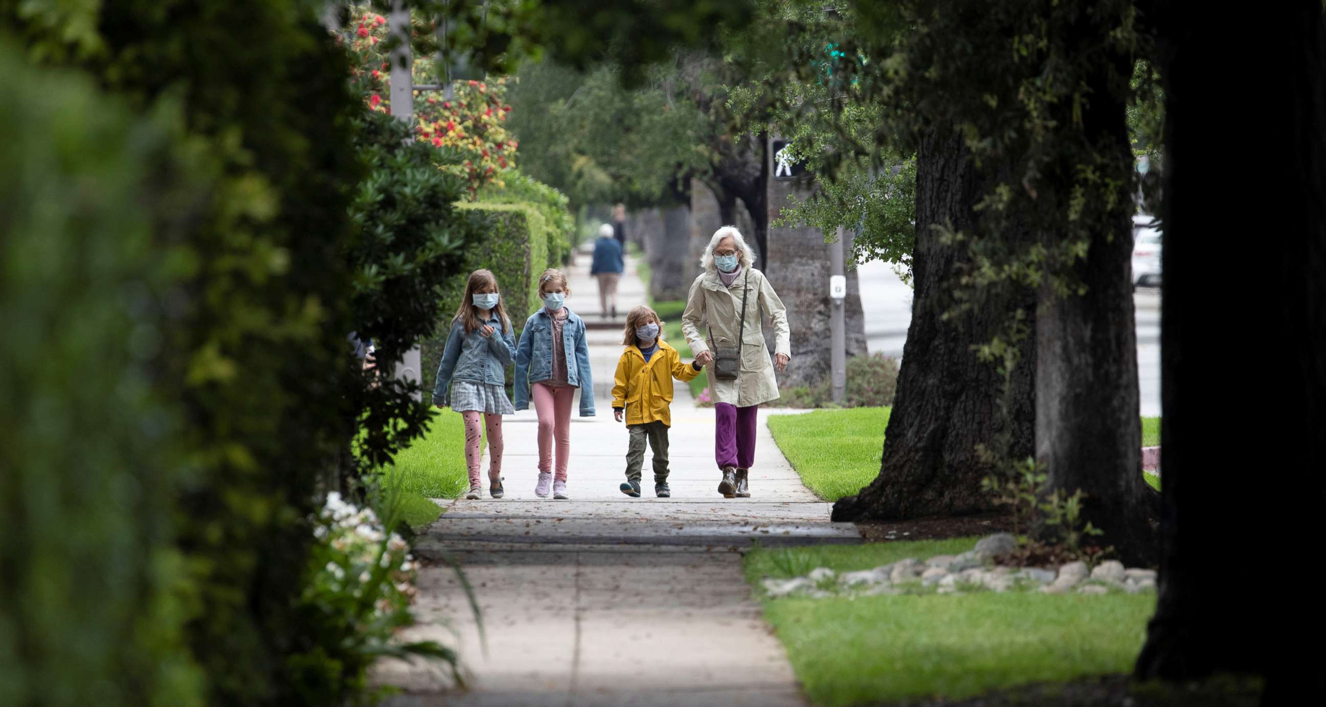 PHOTO: Jillian Ware walks her grandchildren Hugo, Poppy and Violet while wearing face masks during the global outbreak of the coronavirus disease (COVID-19), in Pasadena, California, U.S., April 13, 2020. REUTERS/Mario Anzuoni