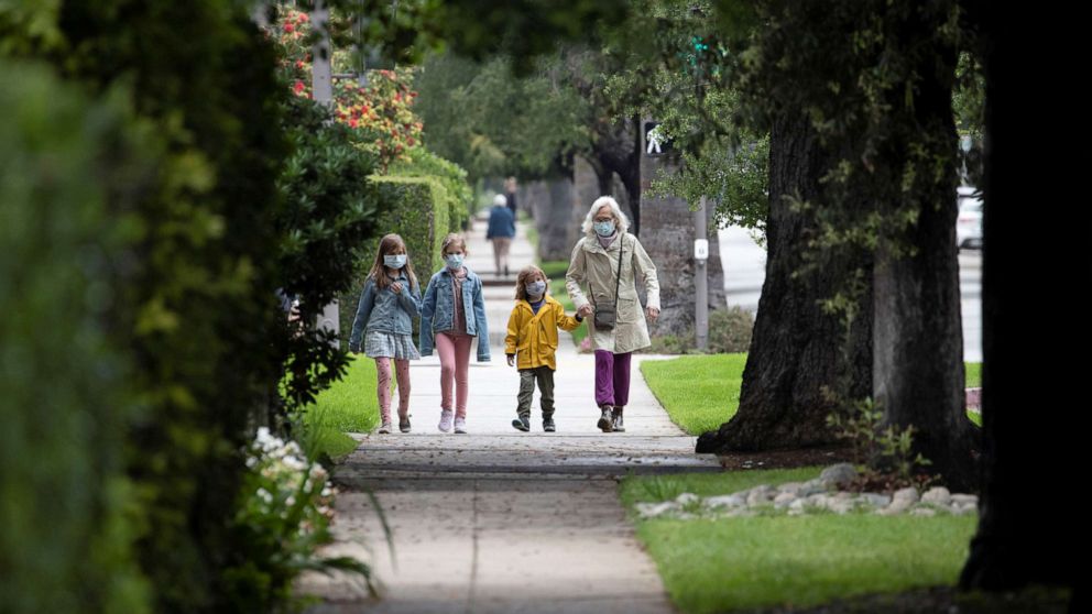 PHOTO: Jillian Ware walks her grandchildren Hugo, Poppy and Violet while wearing face masks during the global outbreak of the coronavirus disease (COVID-19), in Pasadena, California, U.S., April 13, 2020. REUTERS/Mario Anzuoni