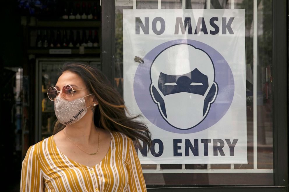 PHOTO: A woman walks out of a liquor store, June 23, 2020, in Santa Monica, Calif.