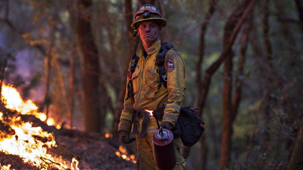 PHOTO: A firefighter uses a drip torch to set a backfire to protect houses in Adobe Canyon during the Nuns Fire on Oct. 15, 2017, near Santa Rosa, Calif.