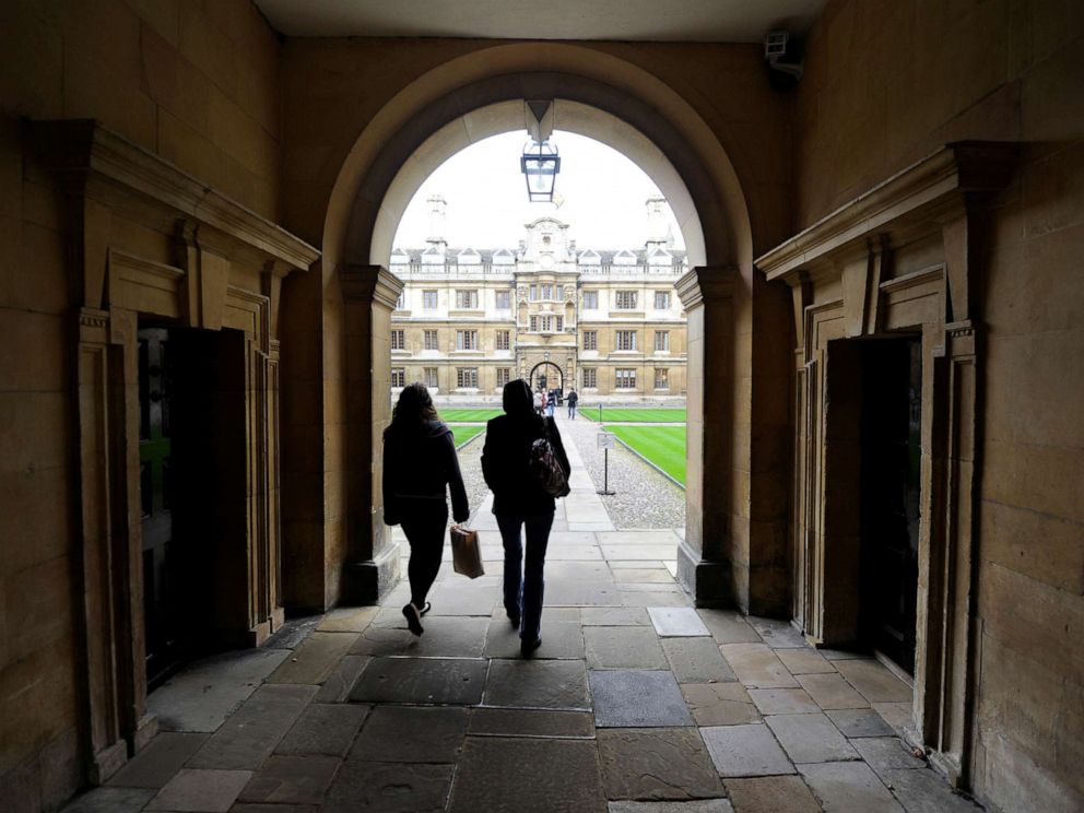 PHOTO: People walk into the quadrant of Clare College at Cambridge University in eastern England Oct. 23, 2010.