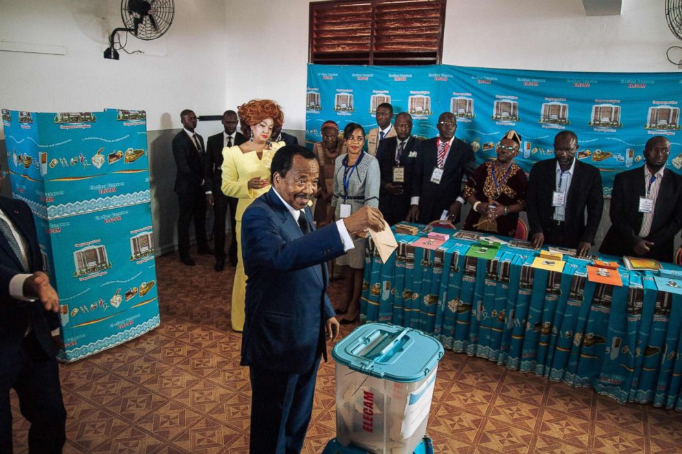 PHOTO: Cameroon's incumbent President Paul Biya casts his ballot as his wife Chantal looks on in the polling station during Cameroon's presidential election, Oct. 7, 2018.