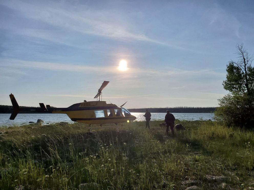 PHOTO: A handout photo made available by the Royal Canadian Mounted Police shows a RCMP officers boarding a helicopter to conduct a search in the Gilliam area of Manitoba, Canada, July 28, 2019.