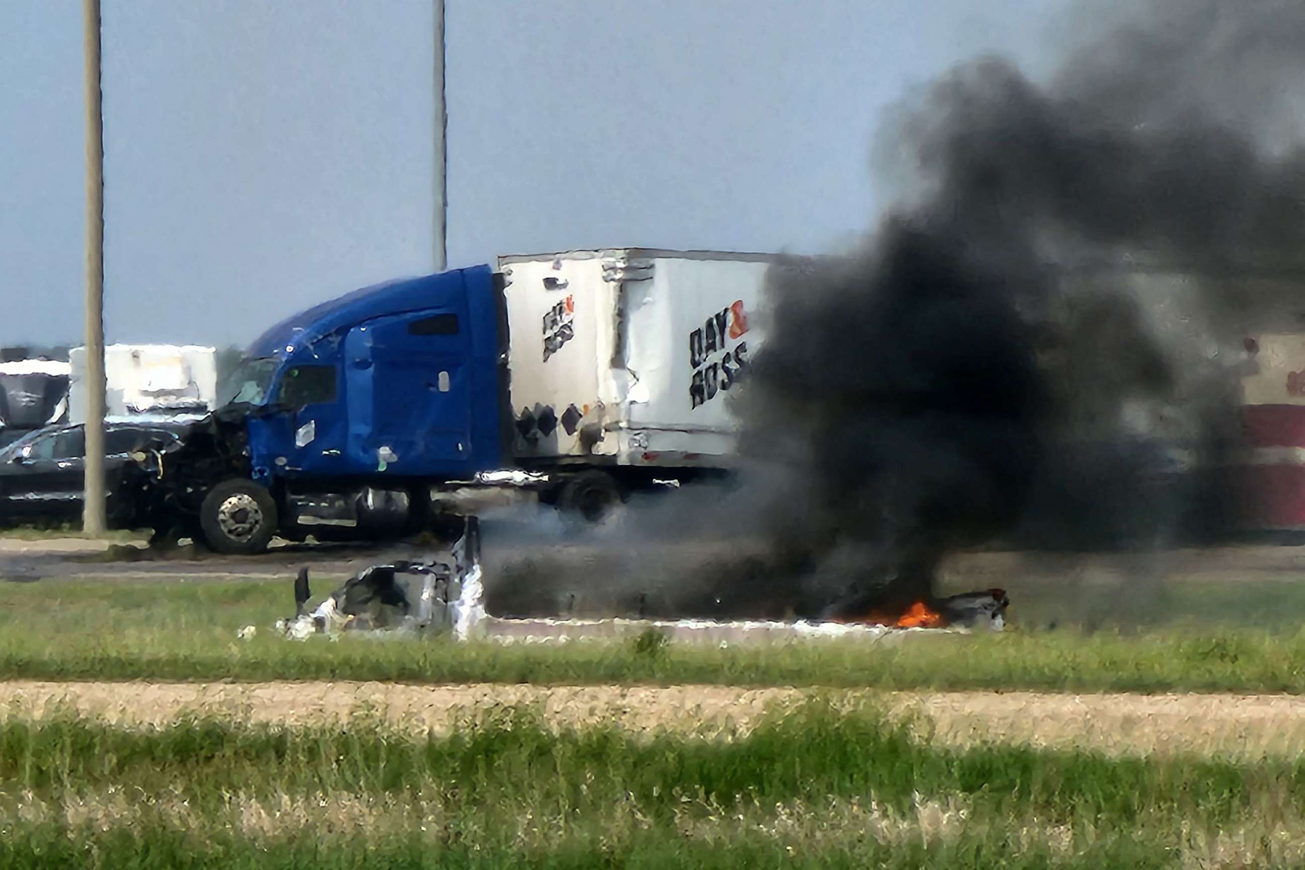 PHOTO: Smoke comes out of a car following a deadly accident near Carberry, west of Winnipeg, Canada, June 15, 2023.