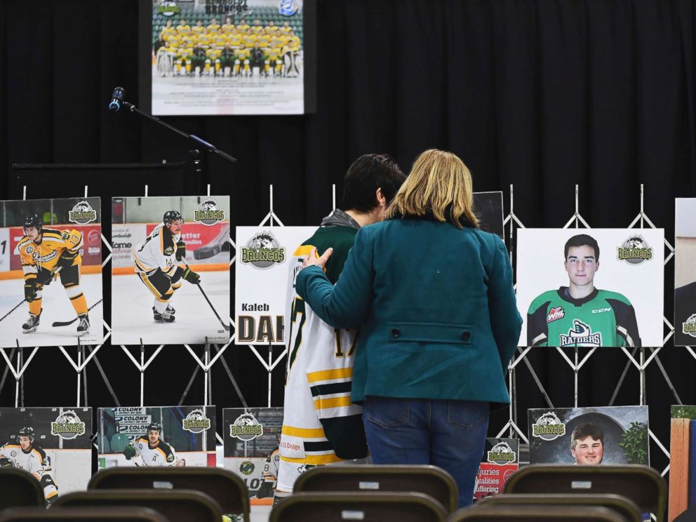 PHOTO: Mourners comfort each other as they look at photographs before a vigil at the Elgar Petersen Arena, home of the Humboldt Broncos, to honor the victims of a fatal bus accident in Humboldt, Canada, April 8, 2018.