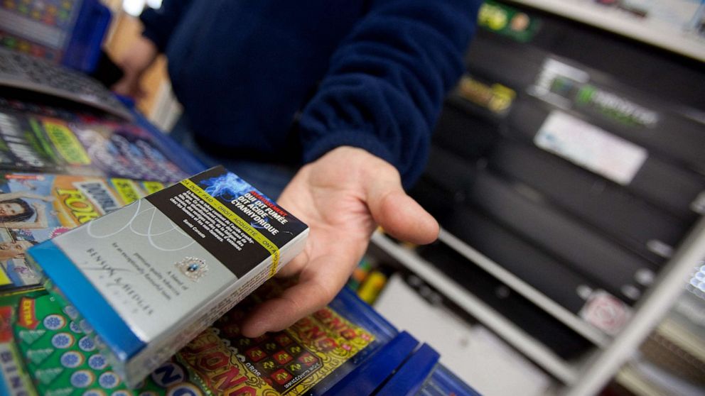 PHOTO: In this file photo, a corner store owner in St. Thomas, Ontario, Canada, holds a package of cigarettes on March 12, 2012.